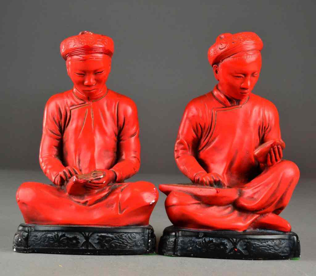Pair Chinese Red Figural BookendsConsisting of matching painted plaster seated
