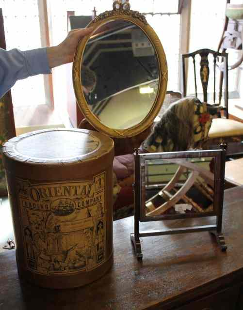 A SMALL OVAL GILT MIRROR an indestructible trunk container of