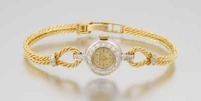 A Ladies Gold and Diamond Dress Watch 14k white gold