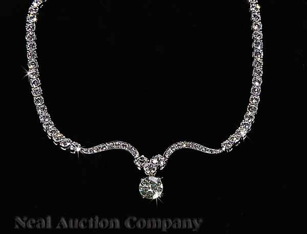 A Platinum and Diamond Necklace set with one round faceted