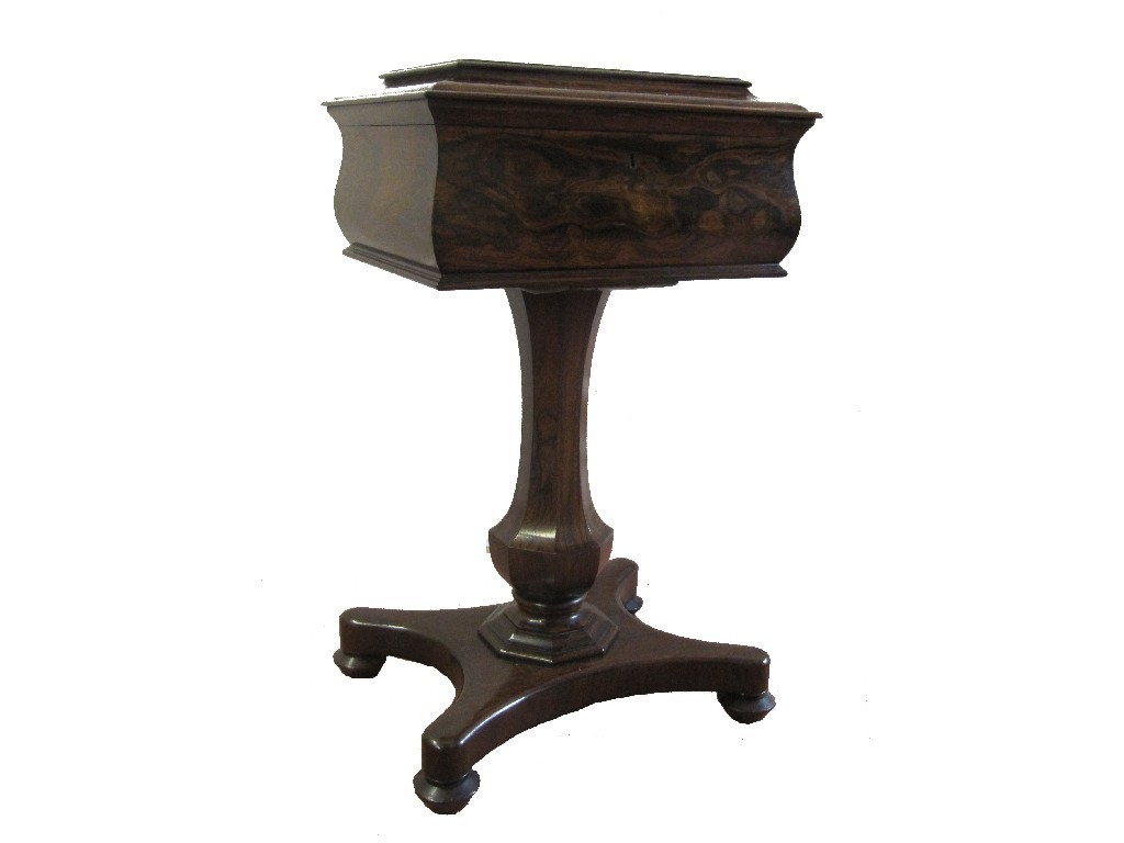 An early Victorian rosewood tea poy the hinged lid revealing