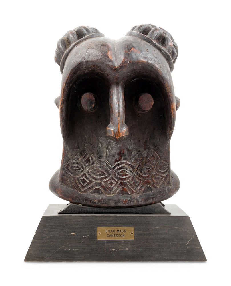 A Bamileke Carved Wood Helmet Mask A Bamileke Carved Wood
