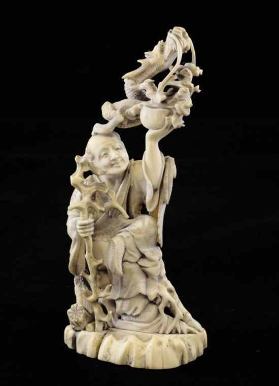 A Japanese sectional ivory and marine ivory figure of a