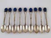 Nine white metal tests silver tea spoons set with blue