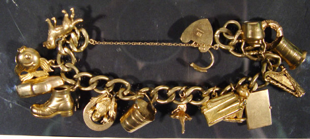 9ct gold charm bracelet set with fifteen assorted charms approx