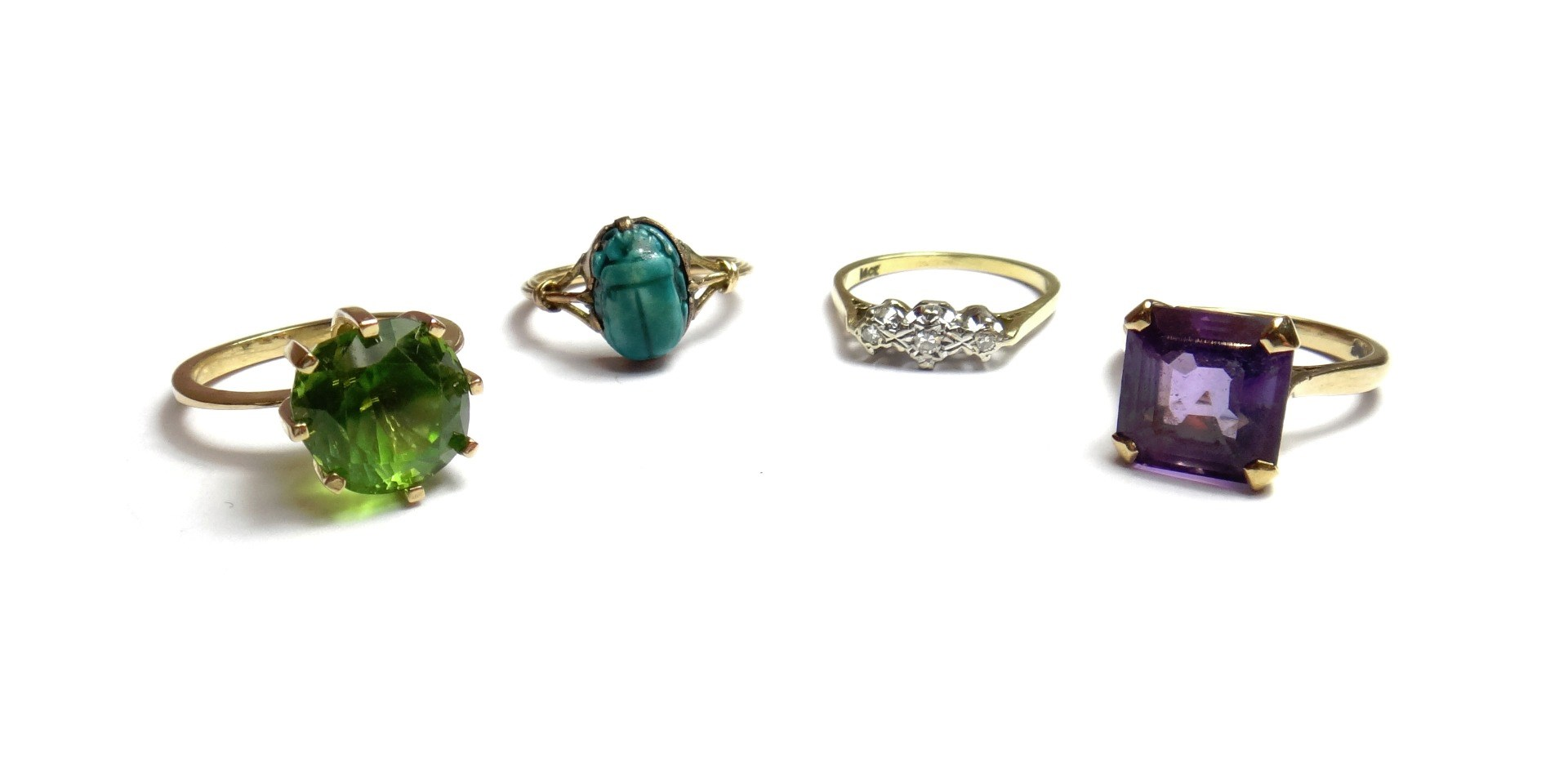 A gold ring claw set with a cushion shaped peridot