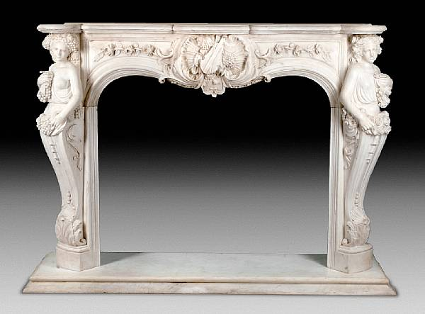 A carved marble fire surround The shaped marble shelf over