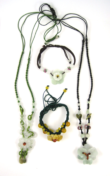 FOUR ARTICLES OF JADE JEWELRY including a black cord necklace