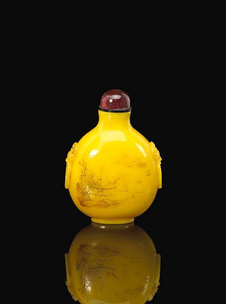 A large engraved yellow glass snuff bottle Qianlong Mark and