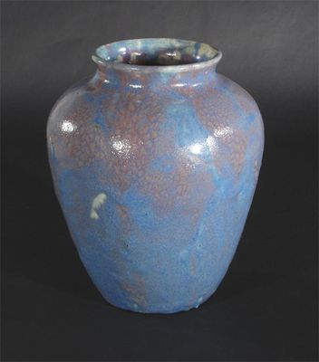 A Coldrum Pottery vase covered in a mottled blue and