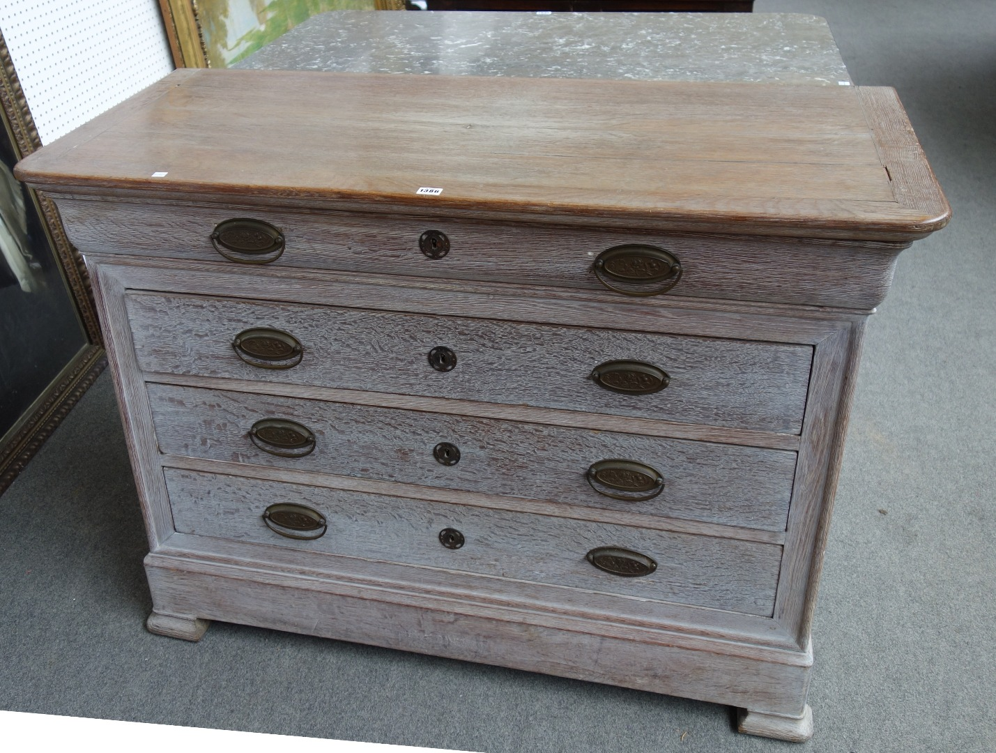 An early 19th century French later limed oak commode of