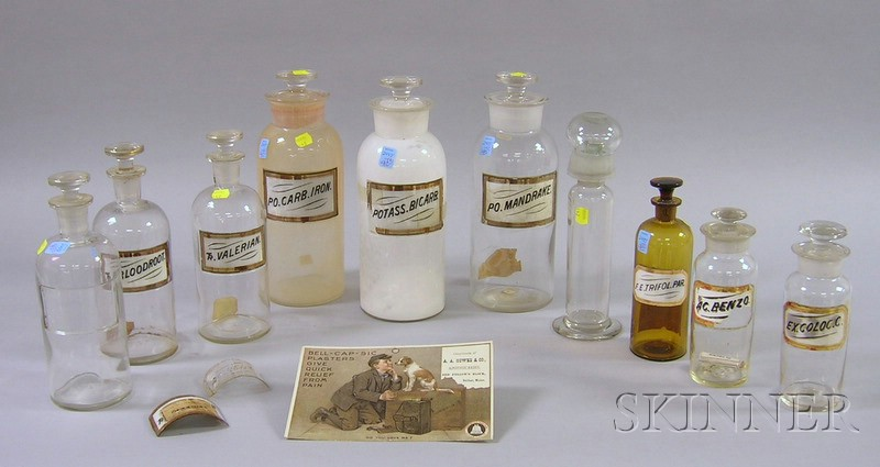 Nine Mostly Colorless Molded and Blown Glass Apothecary Bottles with