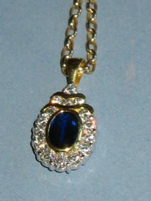 A SAPPHIRE AND DIAMOND PENDANT with oval sapphire 8mm long