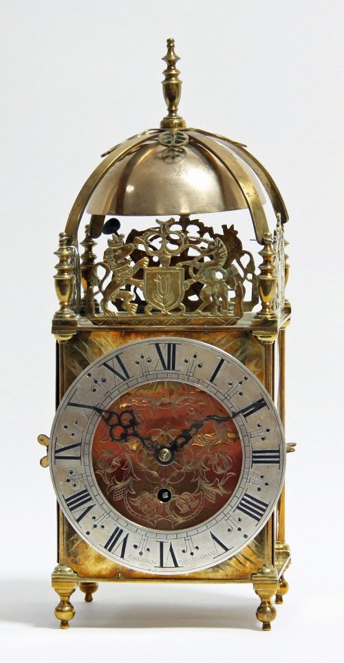 A brass lantern clock of 17th Century design the case