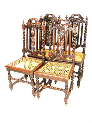 Four matching beech chairs with foliate carved pierced backs above