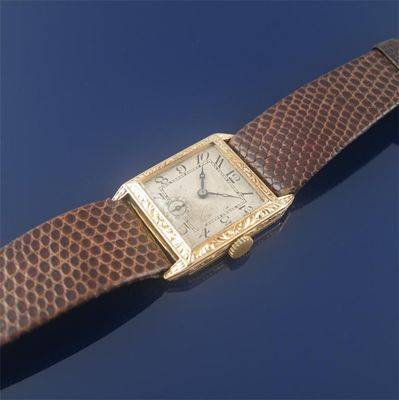 An 18ct gold square faced wrist watch Arabic numerals with