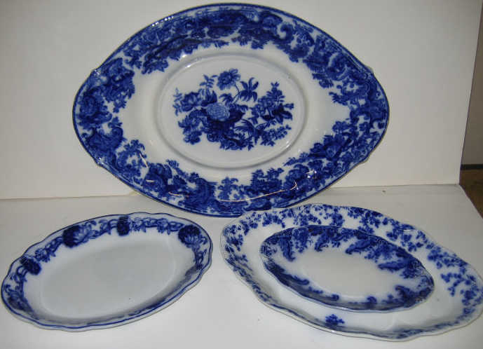 FOUR ENGLISH FLOW BLUE POTTERY PLATTERS Each oval comprising Copeland