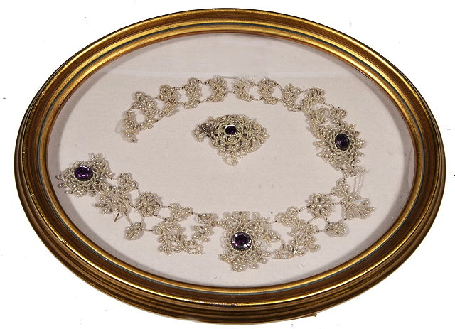 A SEED PEARL NECKLACE of open scroll form inset four