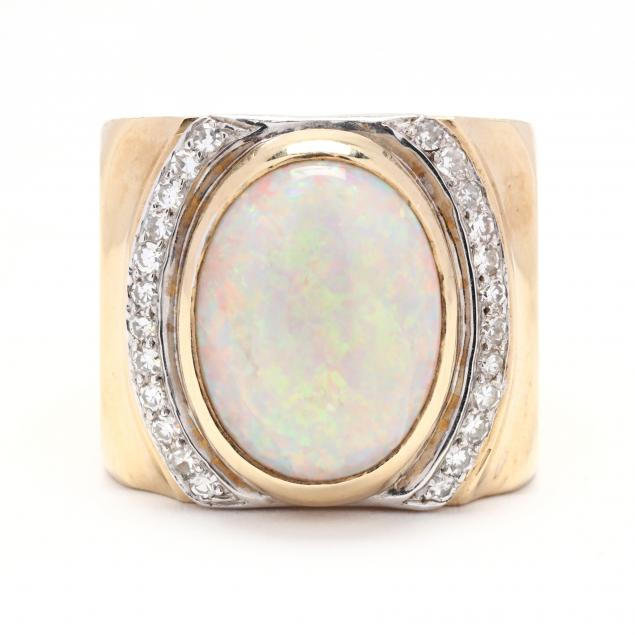 GOLD OPAL AND DIAMOND RING Centering on a bezel set