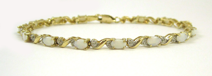 OPAL DIAMOND AND TEN KARAT GOLD BRACELET measuring 7 3