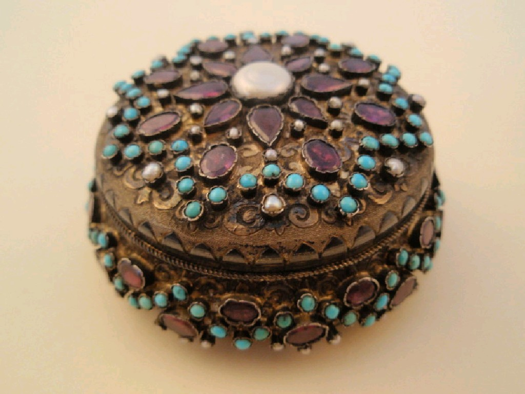 An Indian silver gilt circular lidded box with semi precious