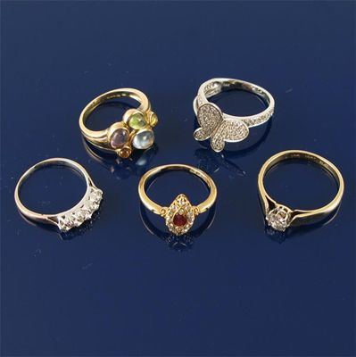 A gold ring set with cabochon stones Case A diamond