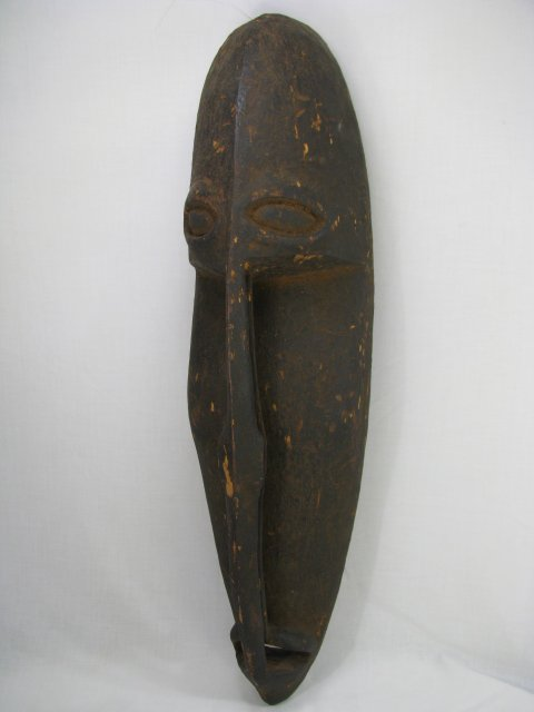 Primitive carved wood mask from the Sepik River area in