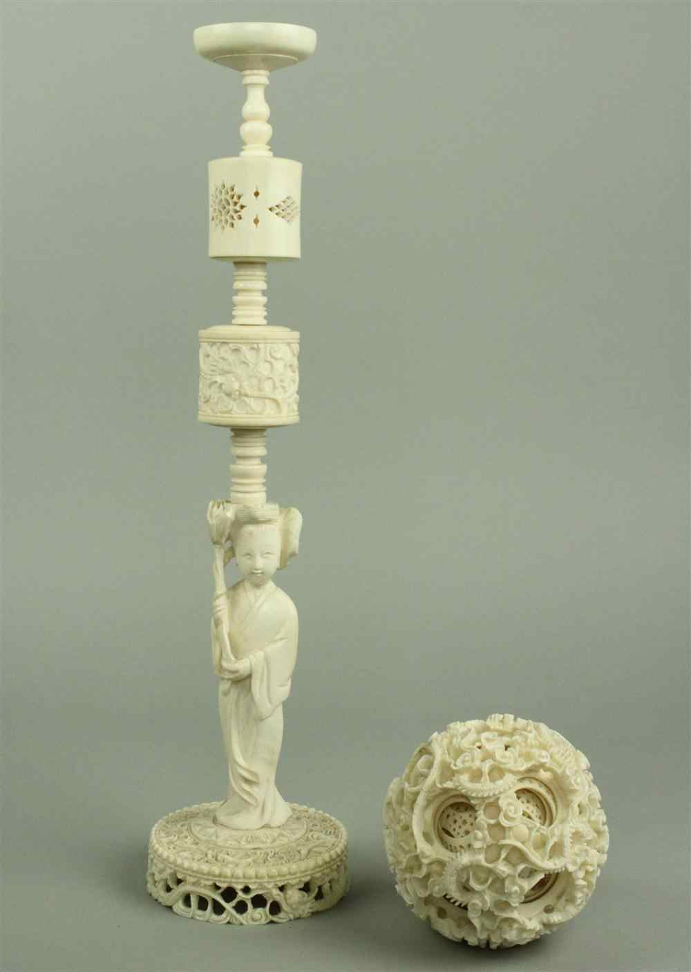 A CHINESE IVORY PUZZLE BALL ON STAND WITH FIGURE OF