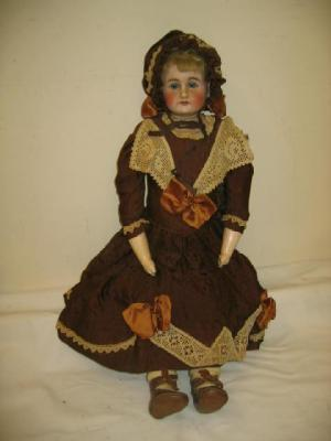 A bisque shoulder head doll with blue sleeping eyes open