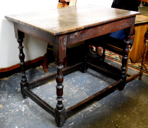 A 17th century oak table the two plank top with