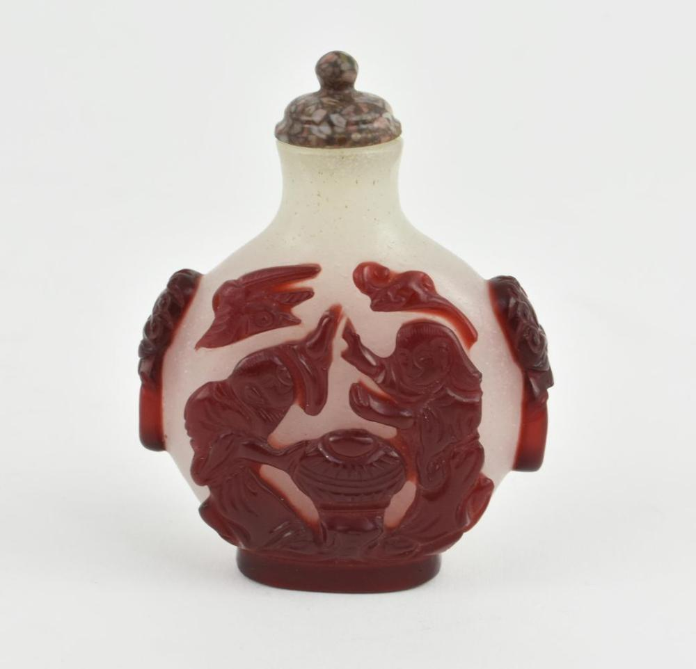 CHINESE RED OVER WHITE PEKING GLASS SNUFF BOTTLEThe flattened circular
