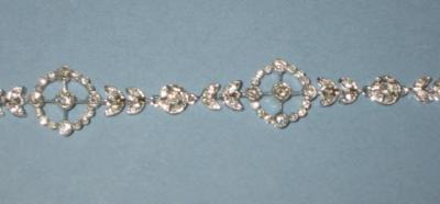 A DIAMOND BRACELET in the Edwardian style comprising pierced circular