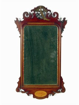 A mahogany fret frame wall mirror with a rectangular plate