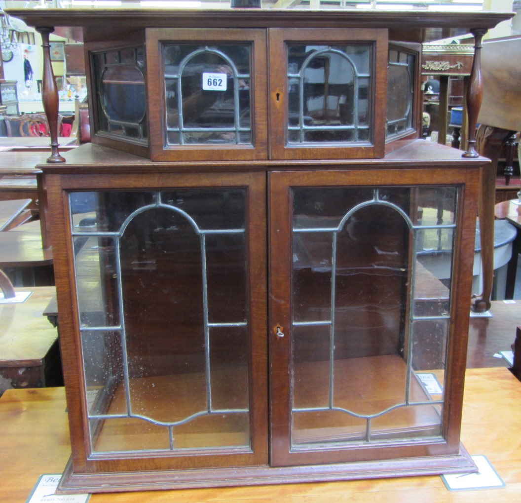 A late 19th century mahogany double section display cabinet with
