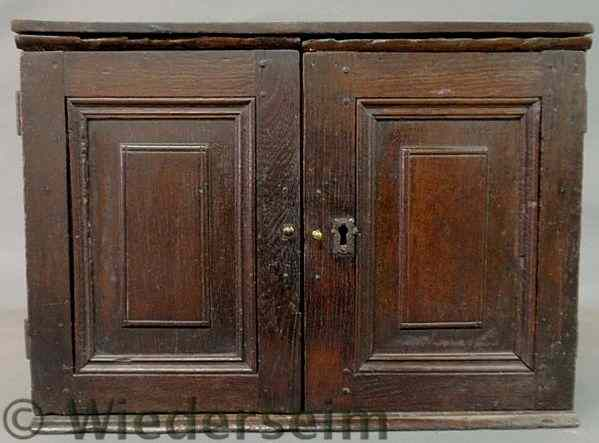 Small English oak cabinet 18th c with raised panel doors