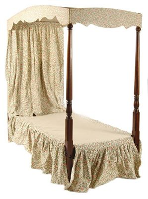 Two single four poster beds each with an arched canopy