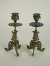 CANDLE STICKS Pair of brass and champleve framed candle sticks