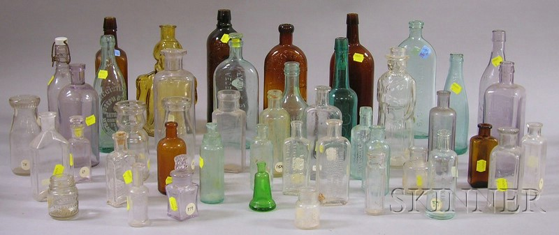 Approximately Seventy Colored and Colorless Glass Bottles molded with labeling