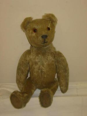 A pre war English teddy bear straw filled covered in