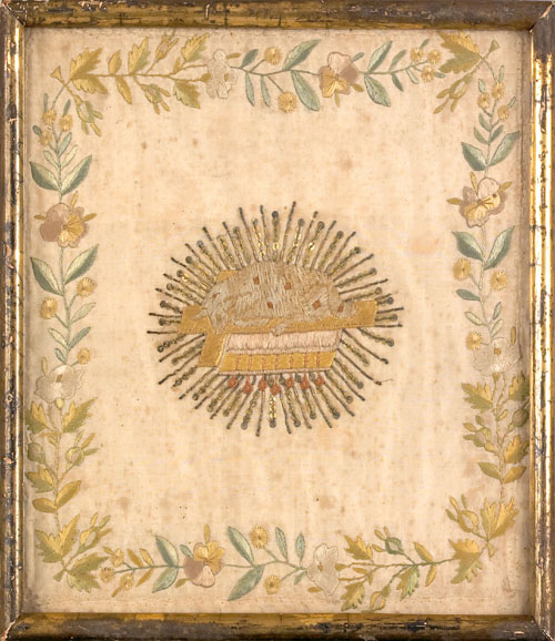 Framed needlework picture ca 1800 with a reclining lamb with