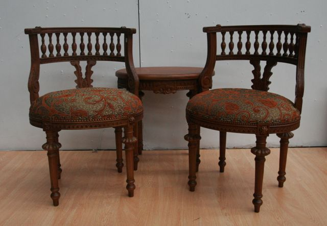A Louis Philippe style walnut parlour suite including two carved