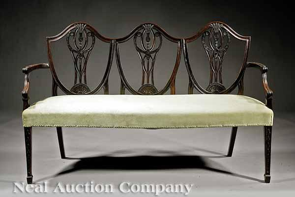 A Federal Style Carved Mahogany Settee triple shield back carved