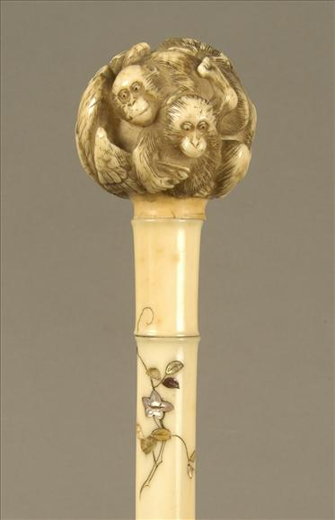 An Edwardian black silk parasol with shibayama handle the globular