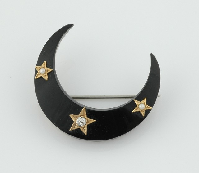 A Victorian jet and diamond brooch Modelled as a crescent