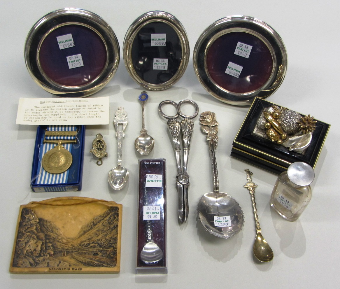 A pair of silver mounted circular photograph frames a silver