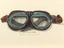 A pair of flying goggles in a glazed oak case