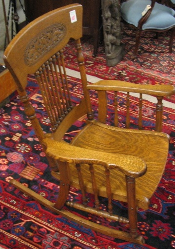 AN OAK SPINDLE BACK ROCKING ARMCHAIR American late 19th century