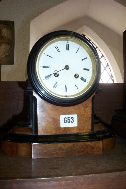A mid 19th century walnut and ebonised mantle clock with