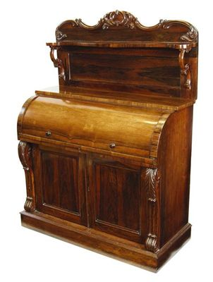 A William IV rosewood cylinder desk the scroll carved and