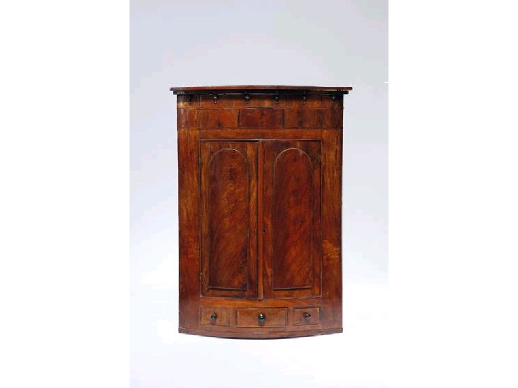 A GEORGE III MAHOGANY HANGING BOWFRONT CORNER CUPBOARD the top